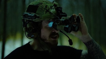 Man wearing the best night vision binoculars