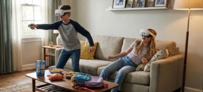 A boy and girl playing with and wearing VR Headsets in living room